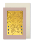 A greeting card with a dusty pink border and a gold foil illustration of a bull under an arch, shown with a cream envelope behind it on a white background.