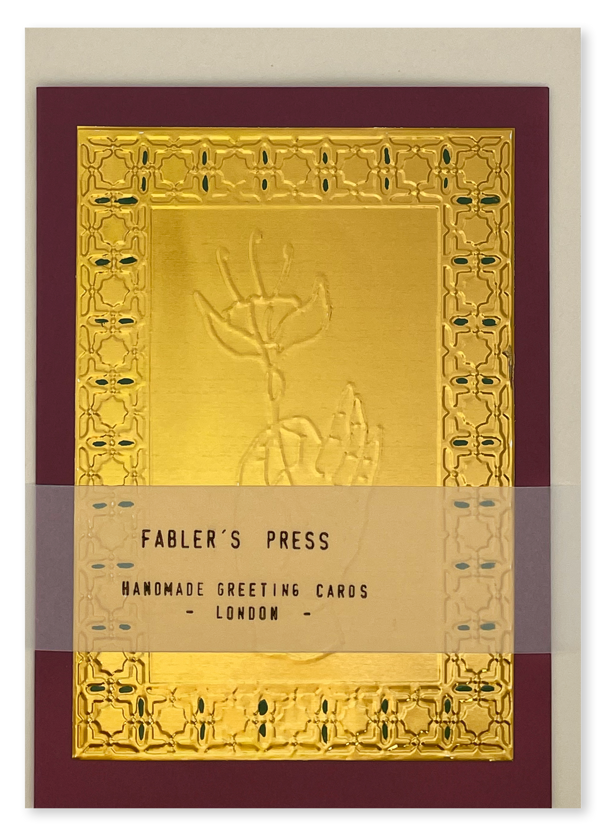 A handmade greeting card from Fabler's Press with an embossed gold foil design and a maroon border, shown with a clear protective sleeve across the front.