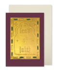 A greeting card with a deep burgundy border and a central gold foil panel embossed with the words 'leap of faith,' shown with a plain cream envelope behind it on a white background.
