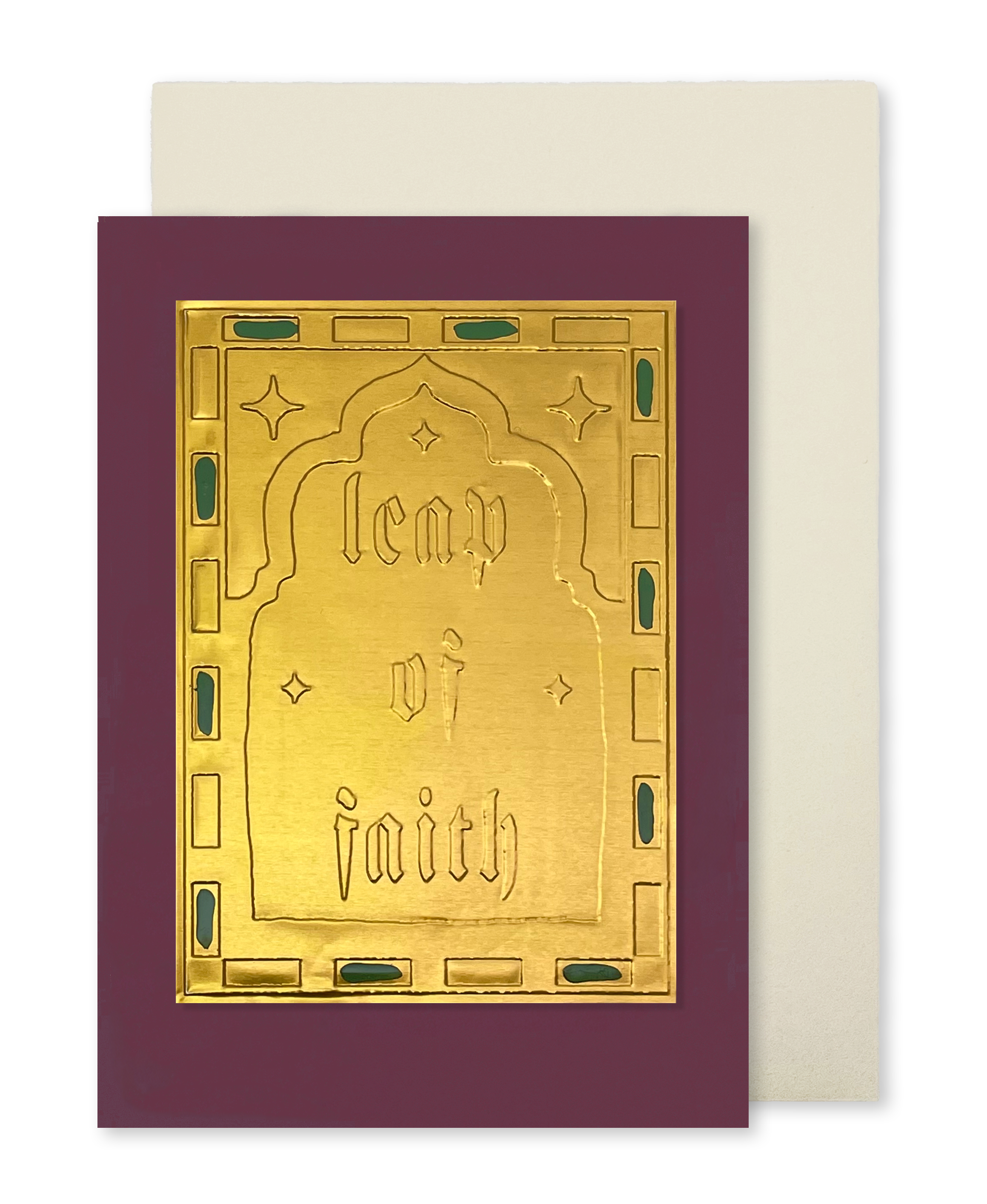 A greeting card with a deep burgundy border and a central gold foil panel embossed with the words 'leap of faith,' shown with a plain cream envelope behind it on a white background.