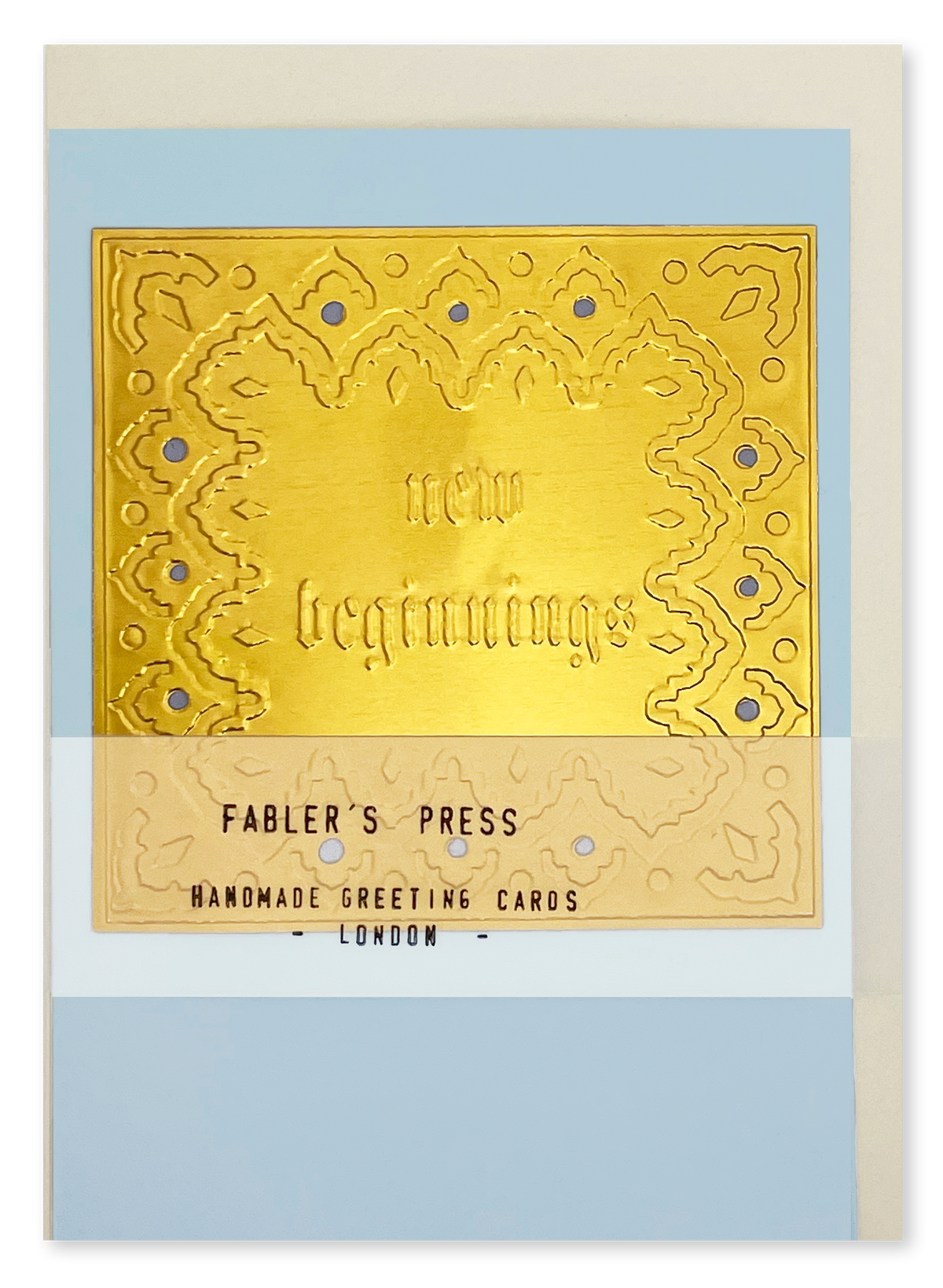 A handmade greeting card from Fabler's Press featuring embossed text "New Beginnings" design on a blue card stock background, wrapped with a translucent band labeled 'FABLER'S PRESS HANDMADE GREETING CARDS LONDON'.