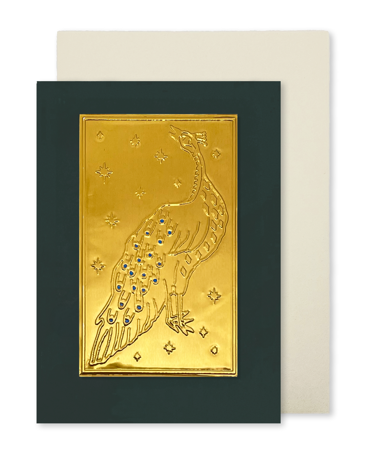 A greeting card with a dark green border and a central gold foil embossed peacock design with blue jewel accents, shown with a cream envelope behind it on a white background.