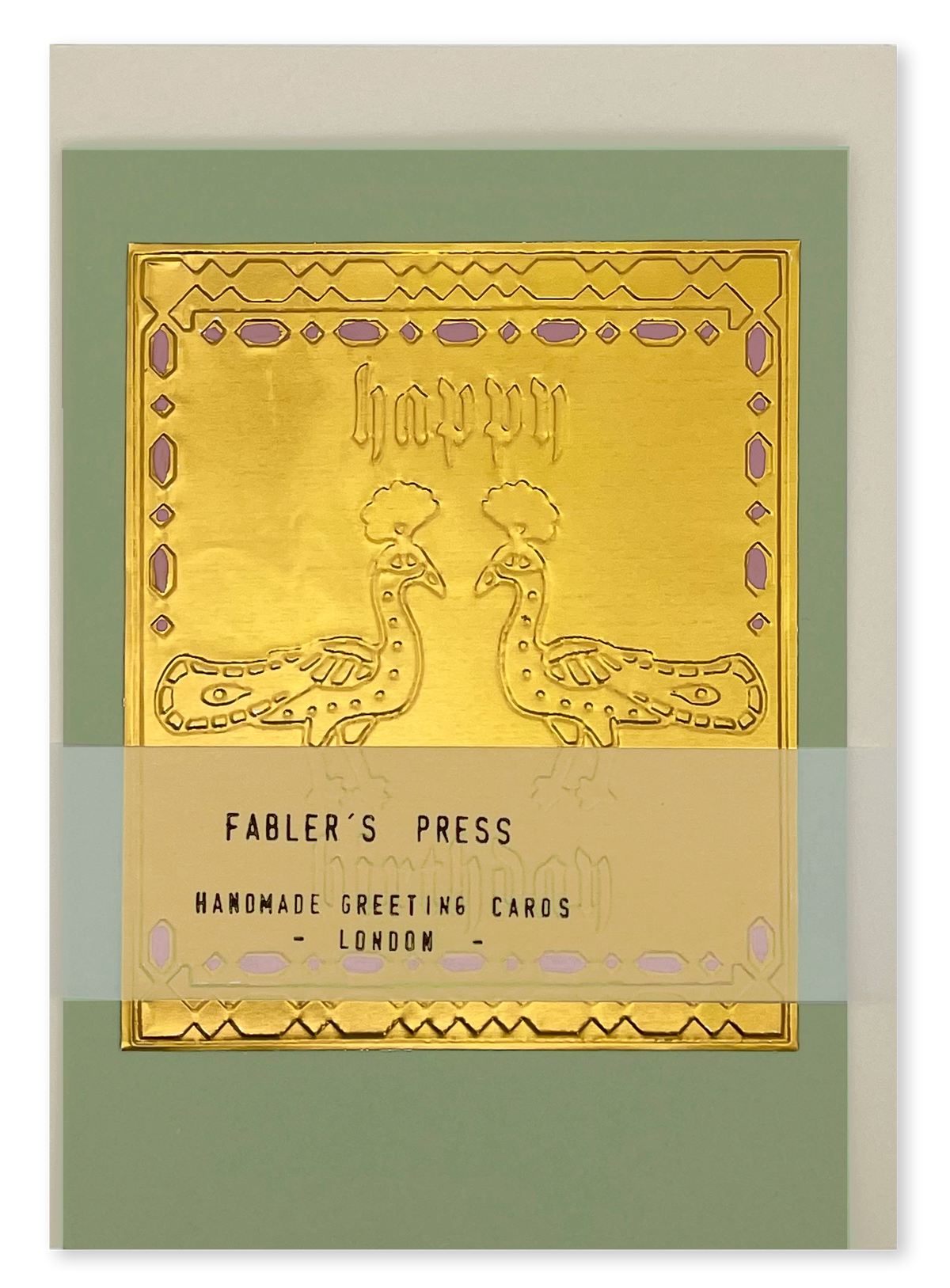 A Fabler's Press handmade greeting card shown on a almond white envelope  background, featuring a closed card with a gold foil peacock design on a sage green background. Also featuring the belly band packaging you get with the card.