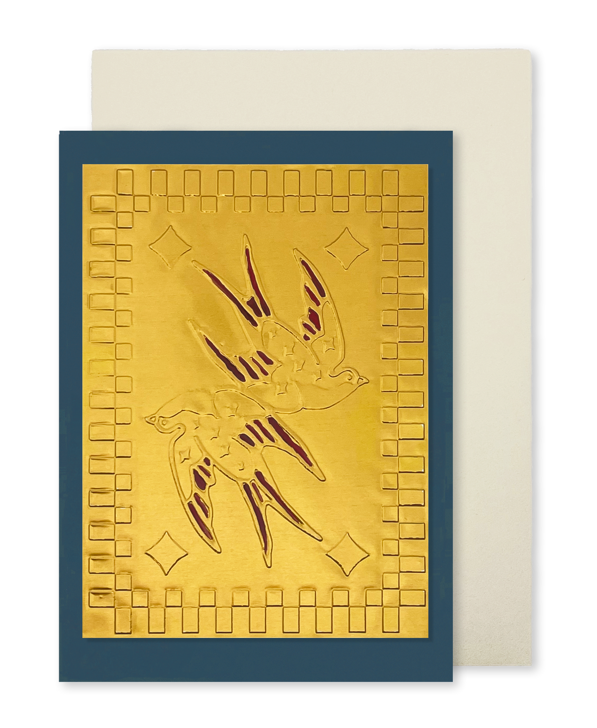 A navy blue greeting card with a raised gold foil panel of 2 swallows with red wings and a square motif border, shown with a cream envelope.